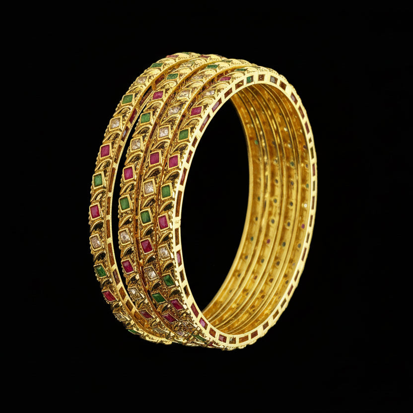 Gold bangles with gemstones on a gray background, featuring the brand 'SAHELI'.