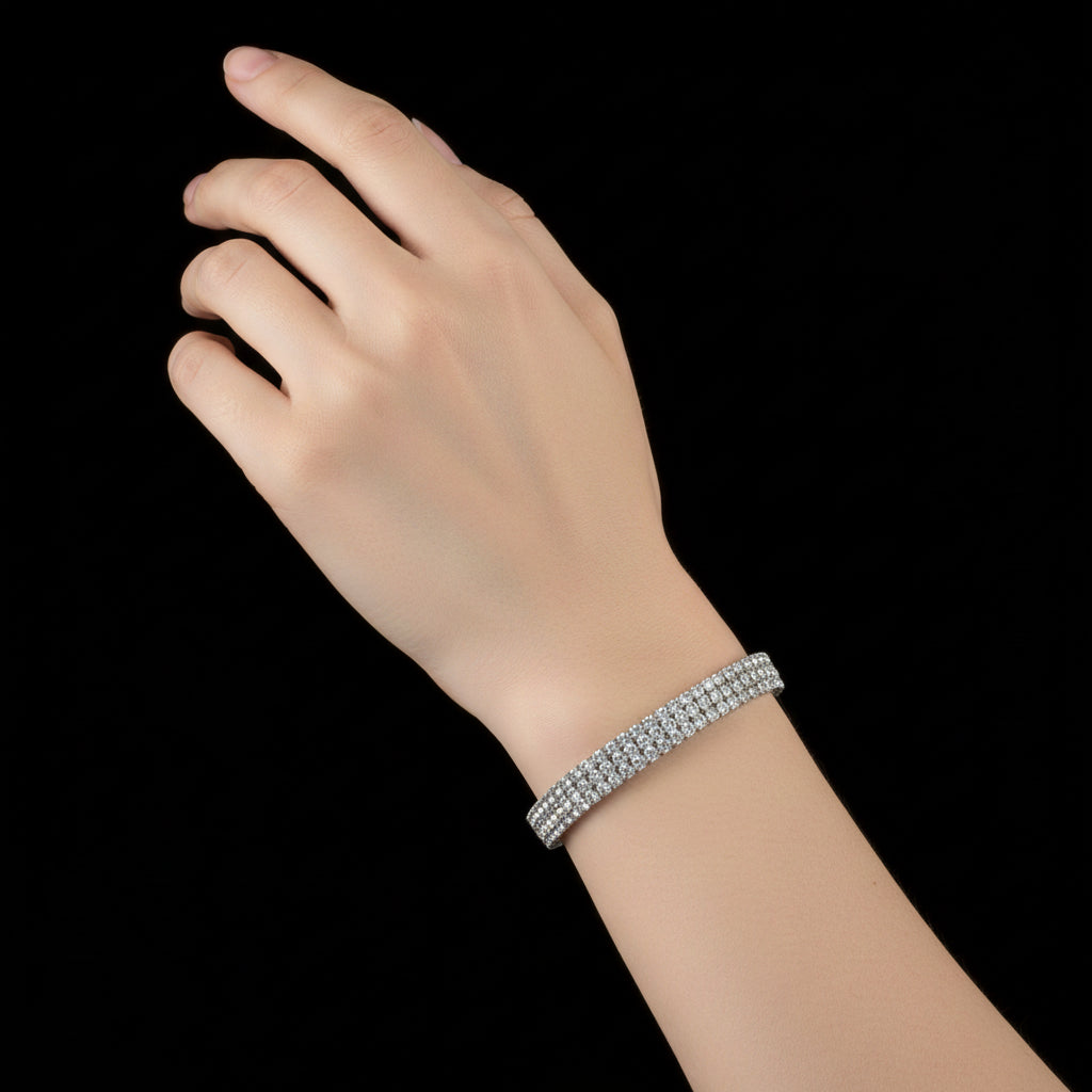 Silver bracelet with clear stones on a black background