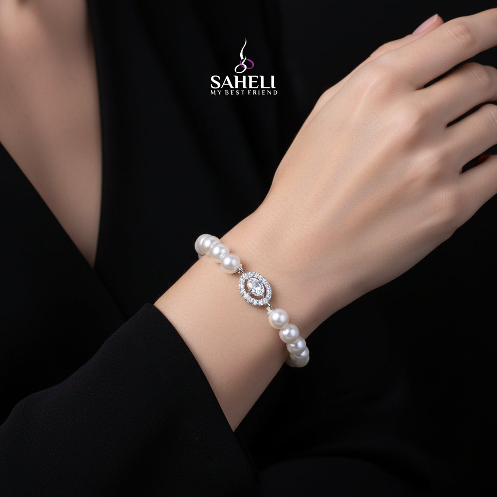 Pearl bracelet with a central diamond on a black background, featuring the brand 'Saheli'.