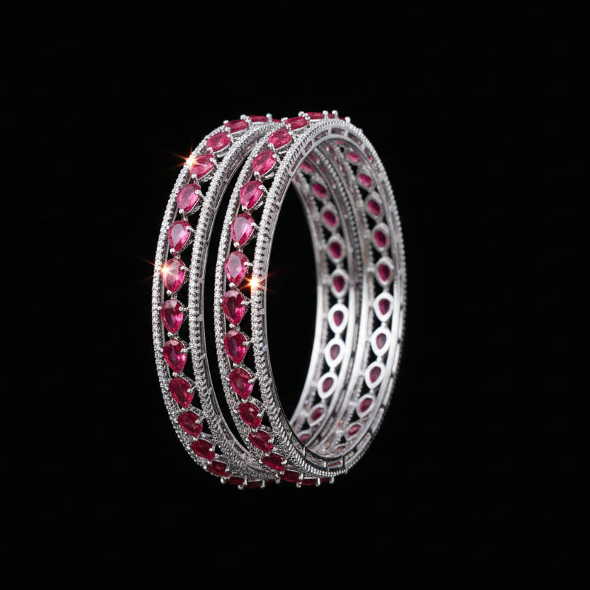 Pair of pink gemstone hoop earrings on a black background with 'SAHELI' brand logo.