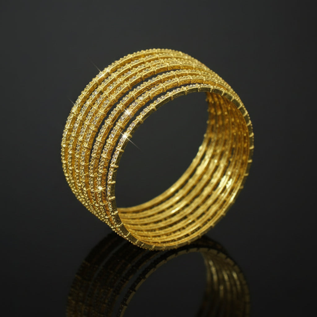 Gold bangles on a black stand with 'SAHELLI' branding in the corner.
