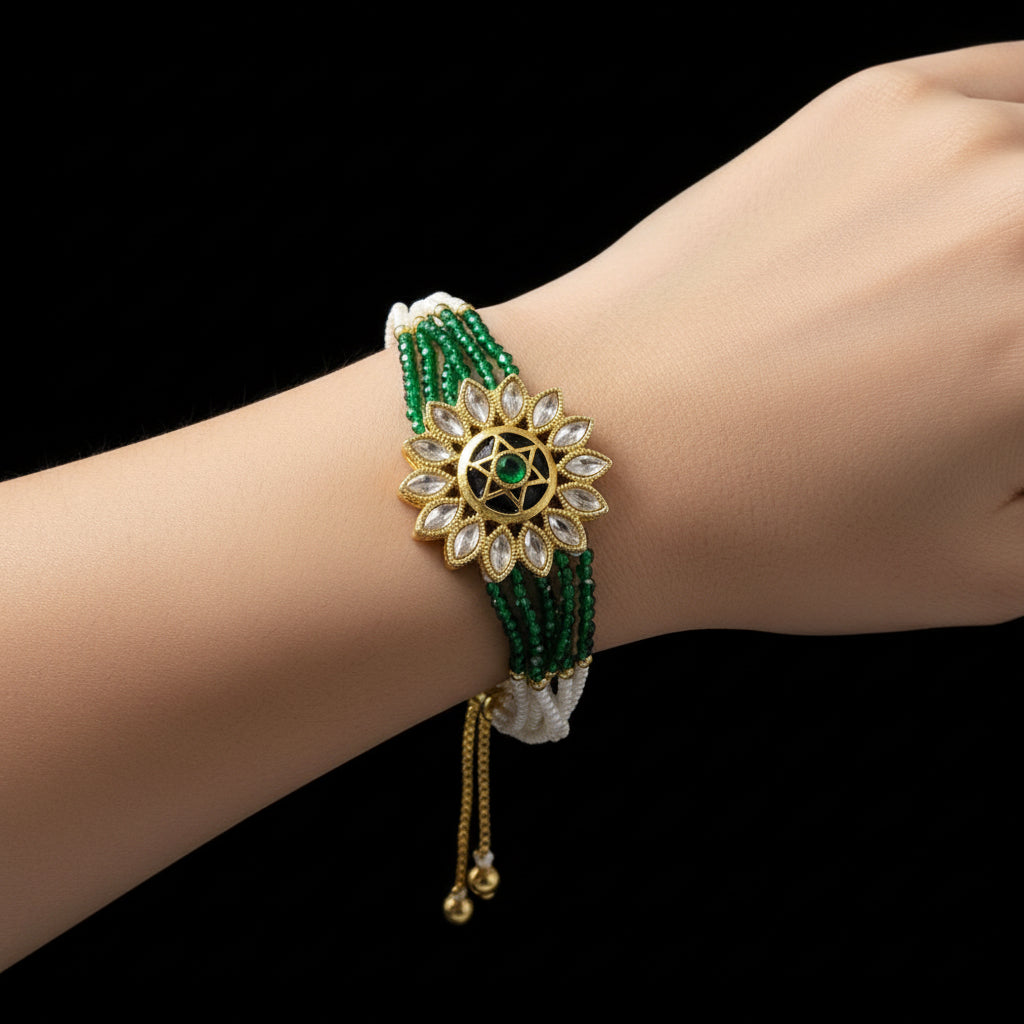 Decorative bracelet with green beads and gold accents on a dark background, featuring the brand 'Saheli'.