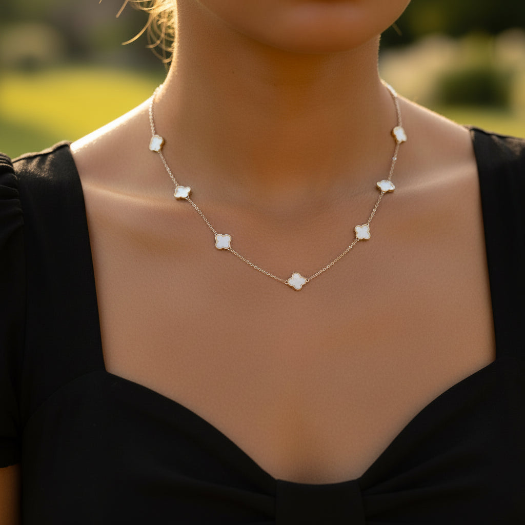 Necklace with floral pendants on a dark background, featuring the brand 'SaheLI'.