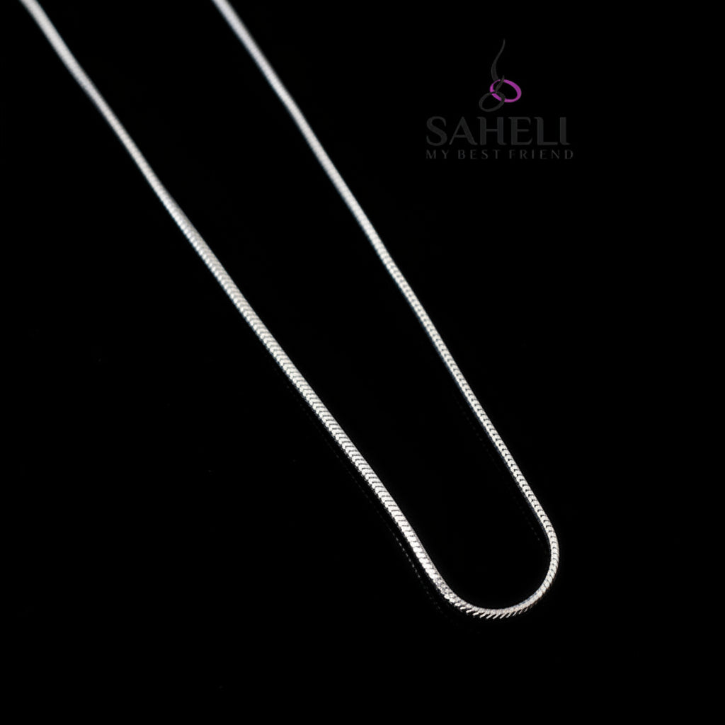 Silver chain necklace on a gray background with 'SAHELI' branding.