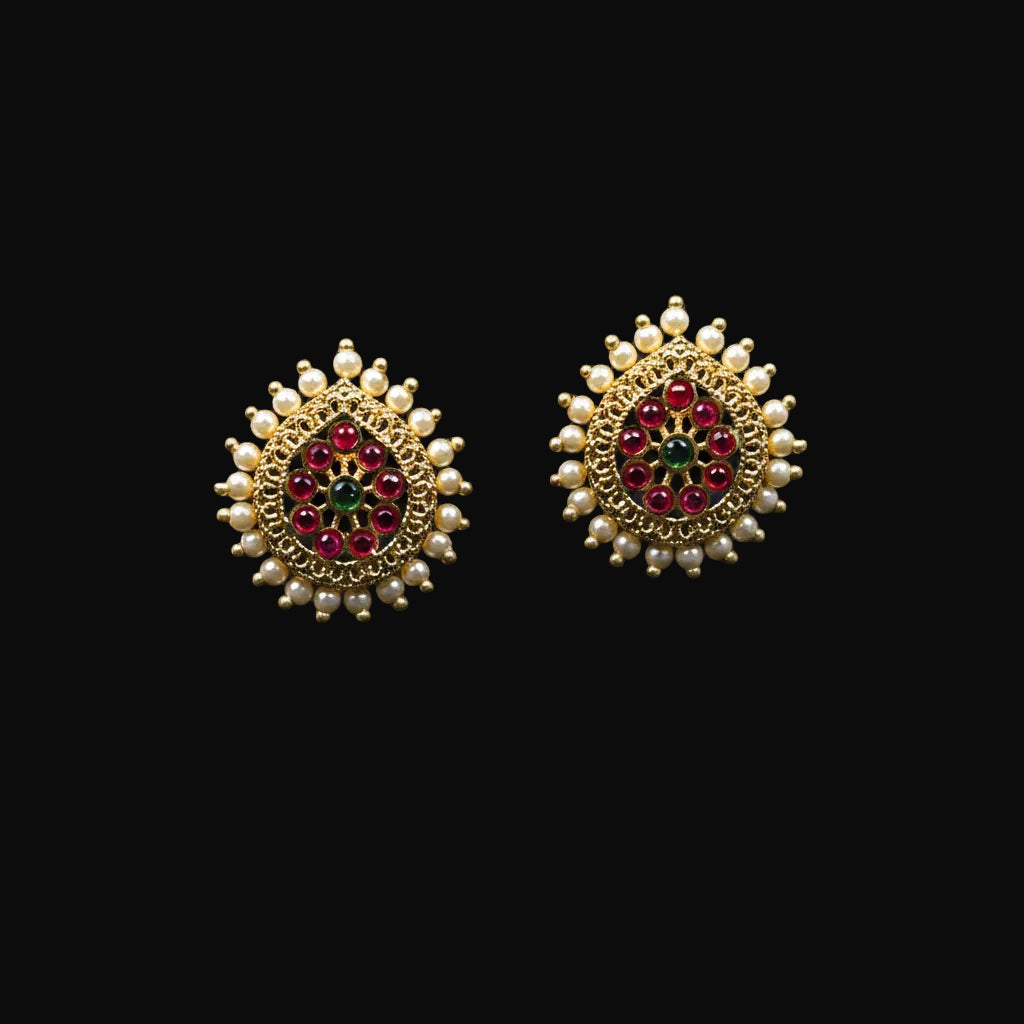 Decorative earrings with gemstones on a black background, featuring the 'Saheli' brand.