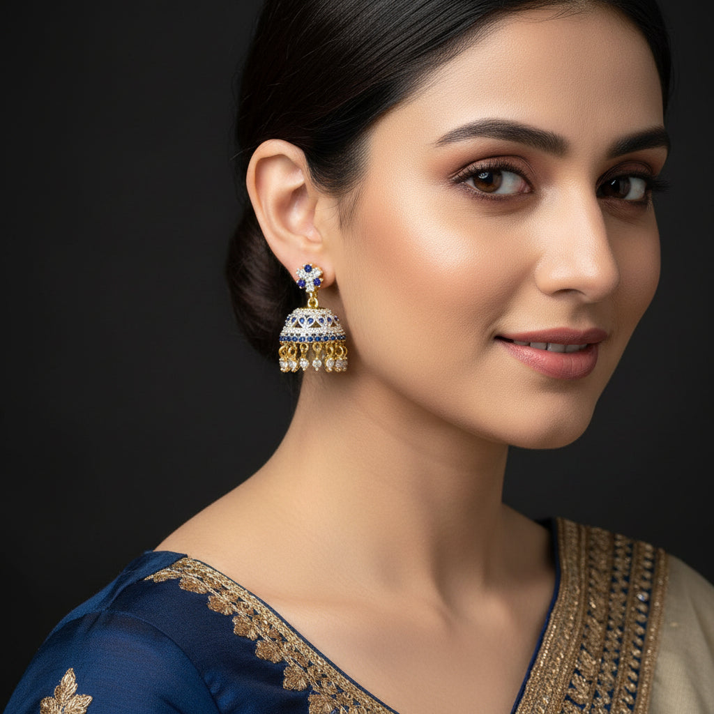 Pair of earrings on a black stand with 'Saheli' branding.