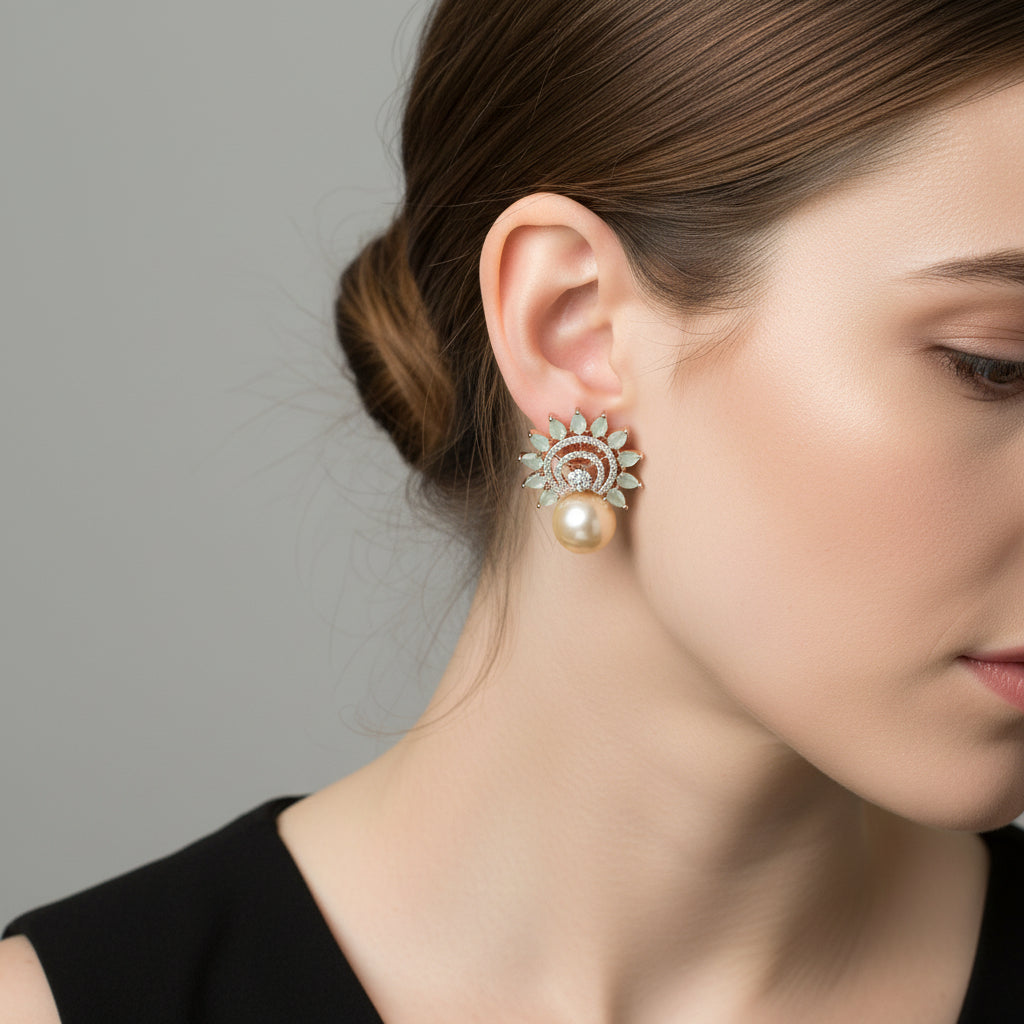 Pair of earrings with pearl-like beads and decorative elements on a dark background