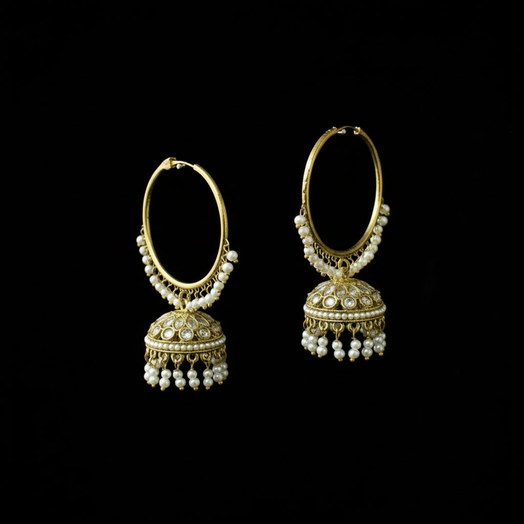 Pair of gold hoop earrings with pearl drops on a black background