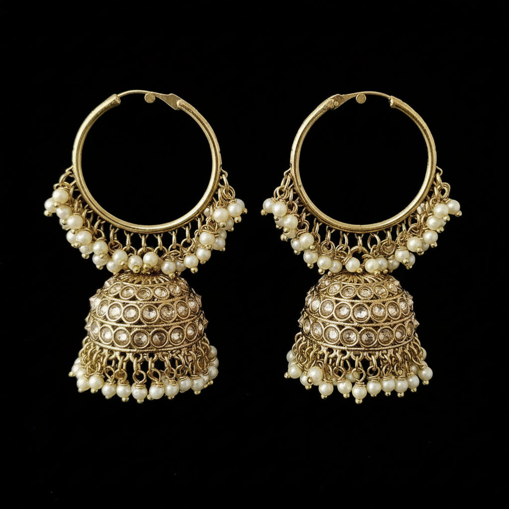 Gold hoop earrings with pearl and crystal details on a gray stand with 'SAHEL' branding.