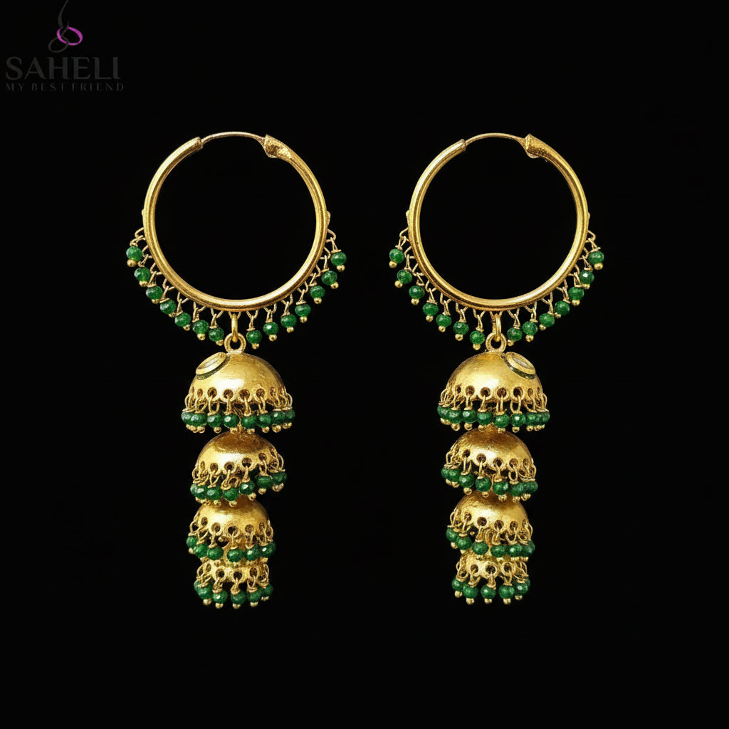 Gold and green earrings on a gray background with 'SAHELI' branding.