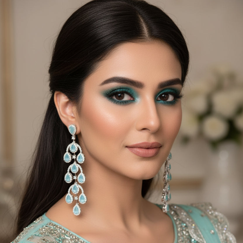 Pair of blue teardrop earrings on a dark background