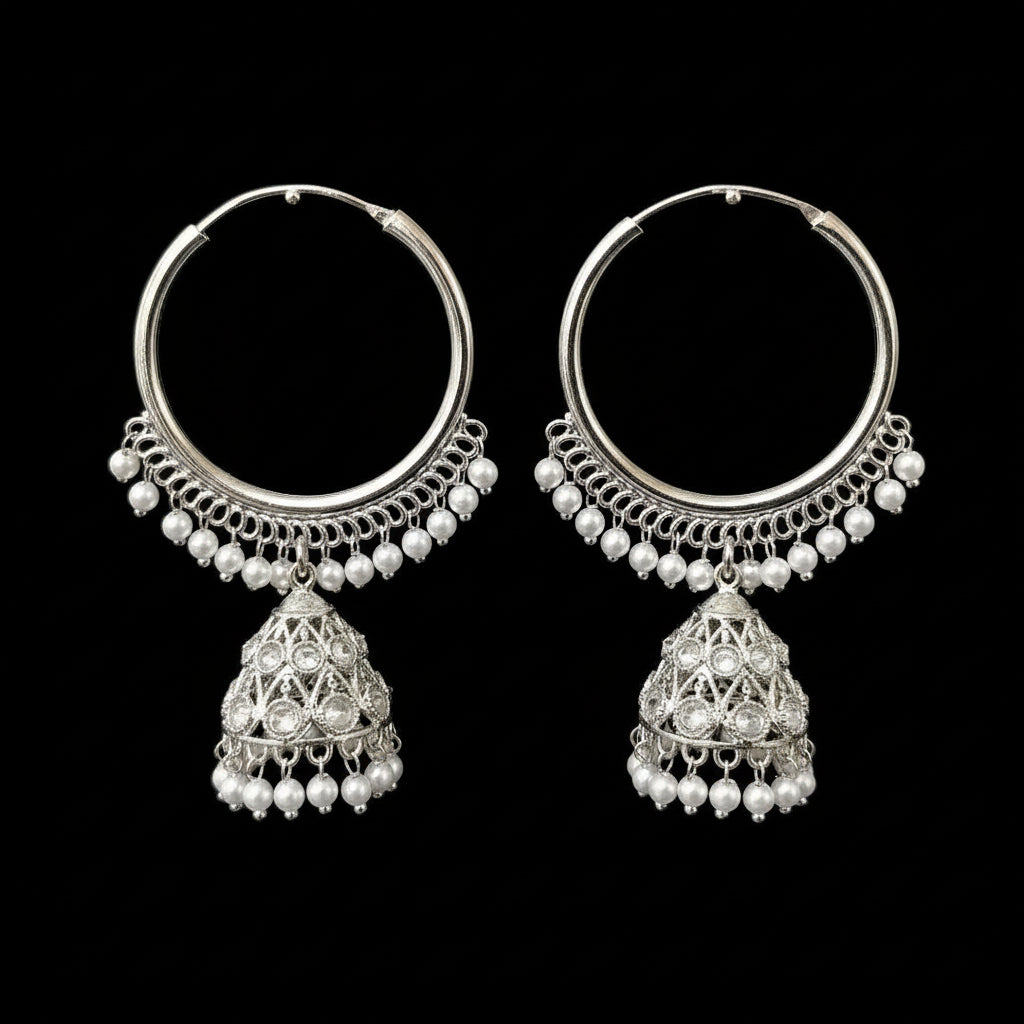 Silver hoop earrings with pearl drops on a gray background, featuring the brand 'Saheli'.