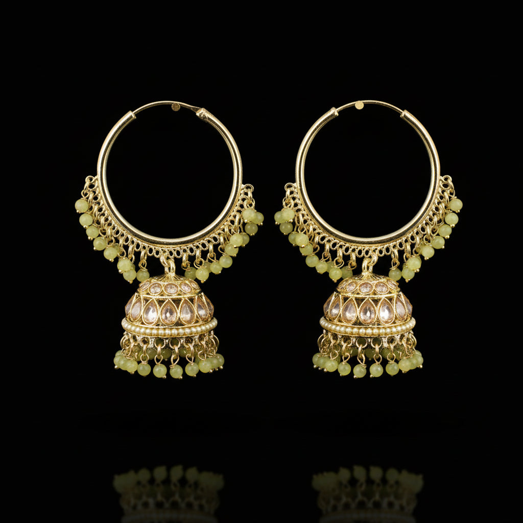 Gold hoop earrings with green beads on a gray background, featuring the brand 'Saheli'.
