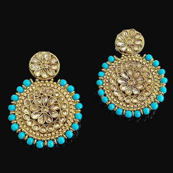 Gold and turquoise earrings on a gray background with 'Saheli' branding.