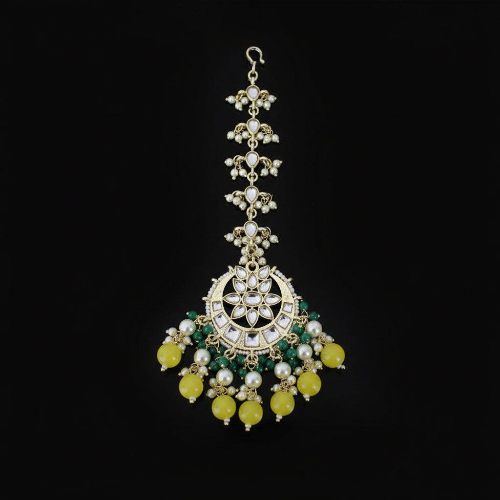Decorative necklace with green and yellow stones on a dark background