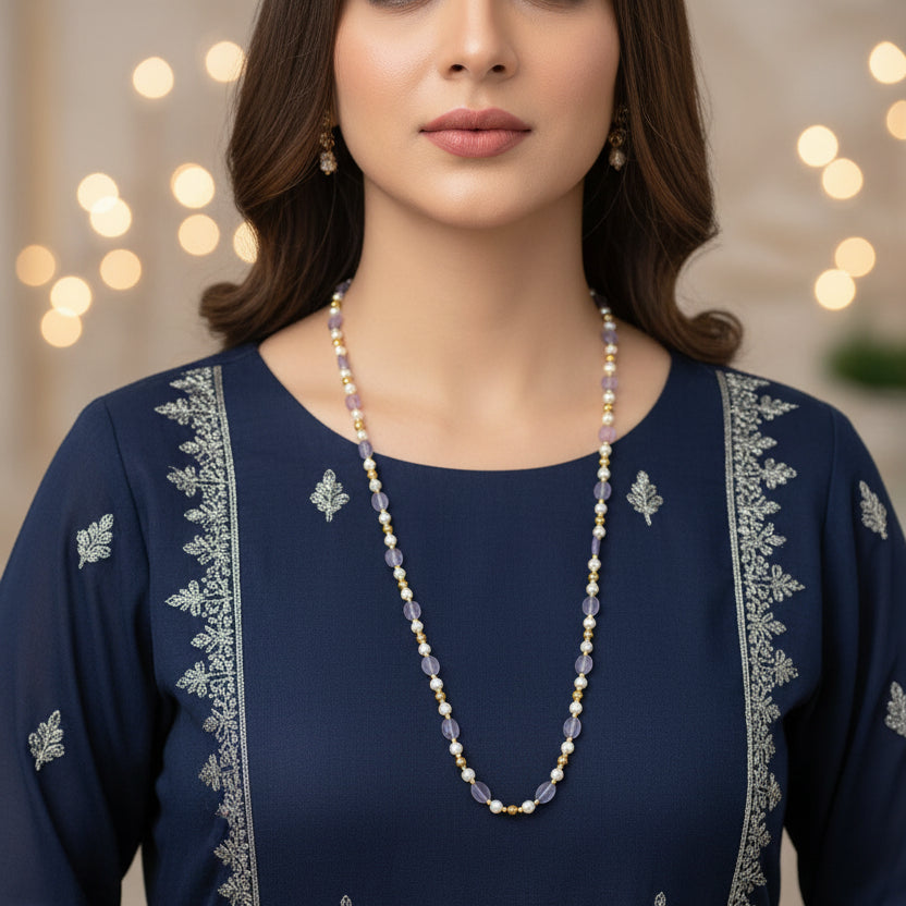 Necklace with alternating gold and light blue beads on a dark background