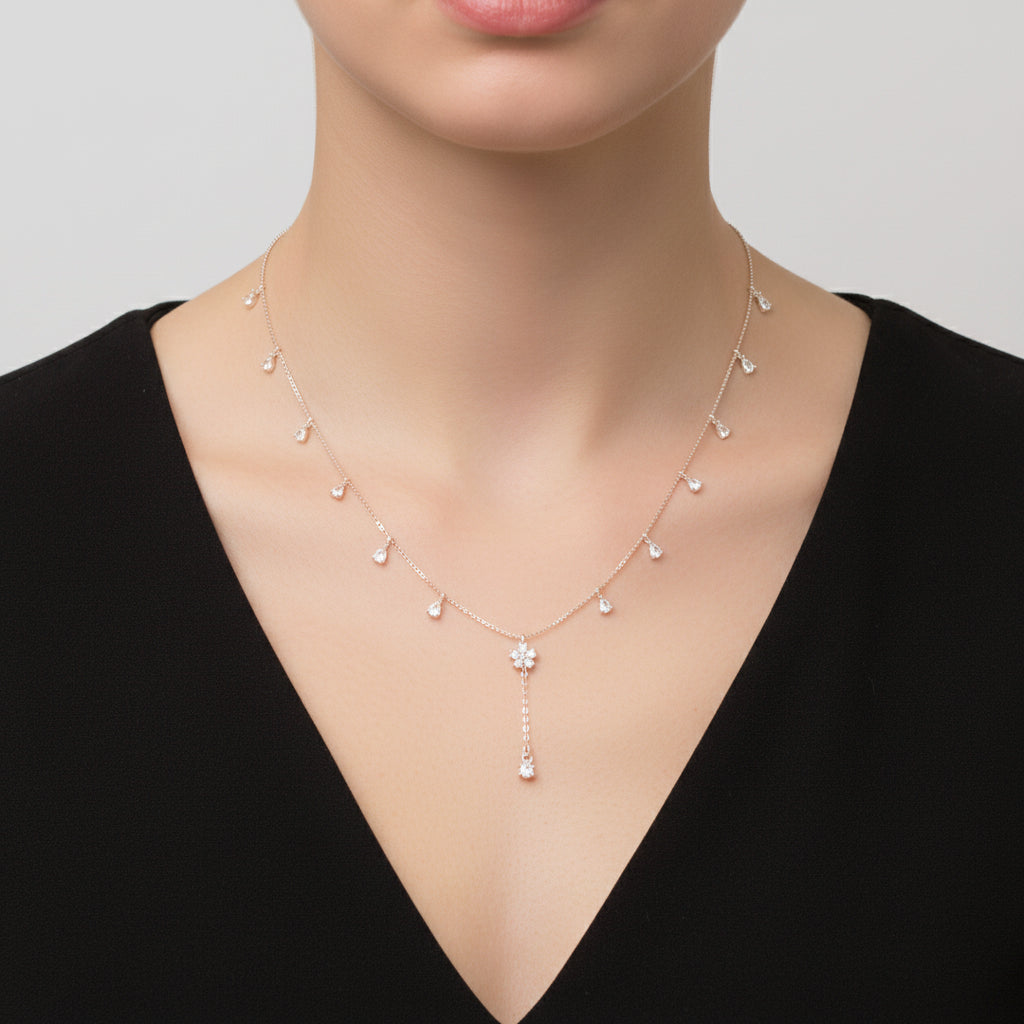 Gold necklace with floral pendant on a dark background