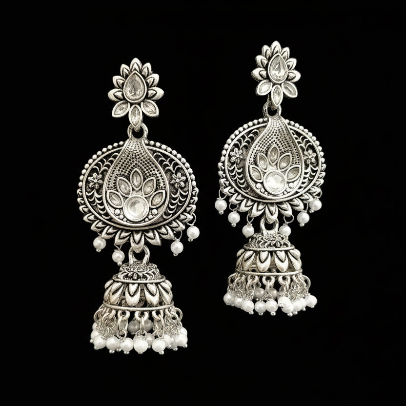 Pair of silver earrings with pearl accents on a gray stand with HP logo.