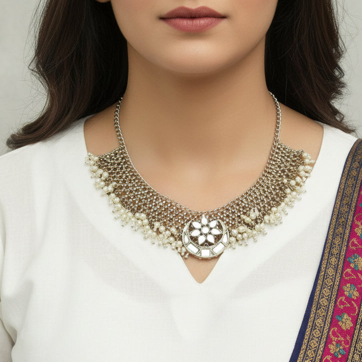 Necklace with white beads and decorative elements on a dark background