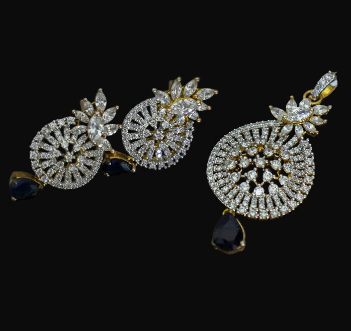 Pair of diamond earrings with black stones on a dark background