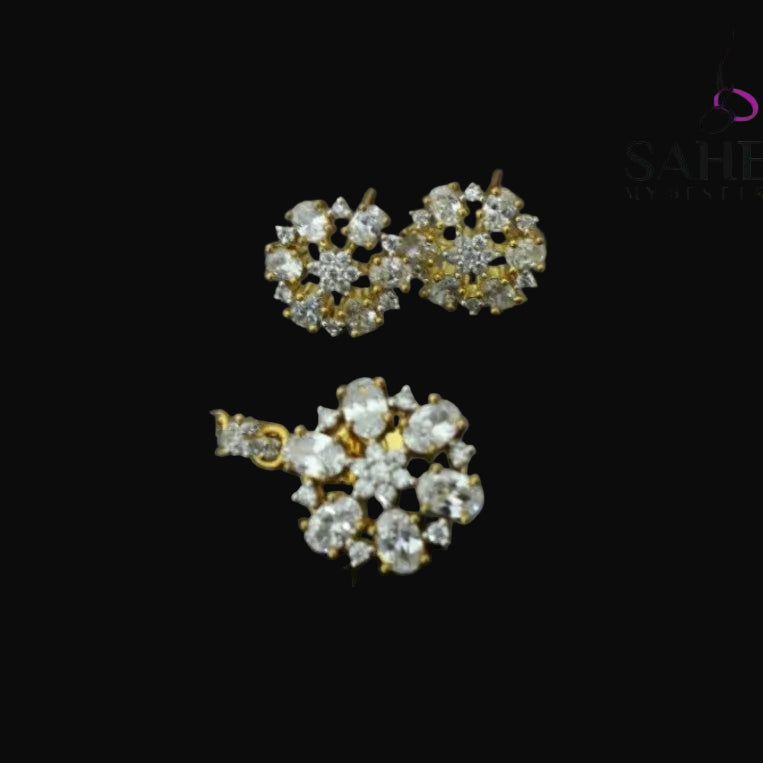 Pair of diamond earrings on a gray background with 'Sahelli' branding.