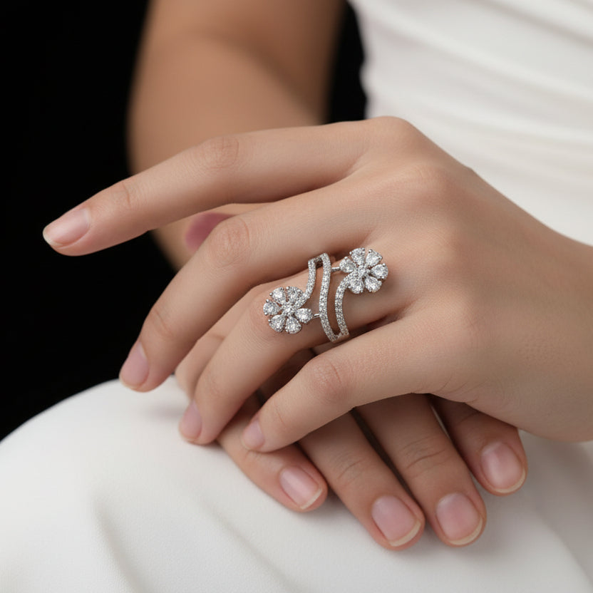 Silver floral earring on a black background with 'SAHEL' branding.