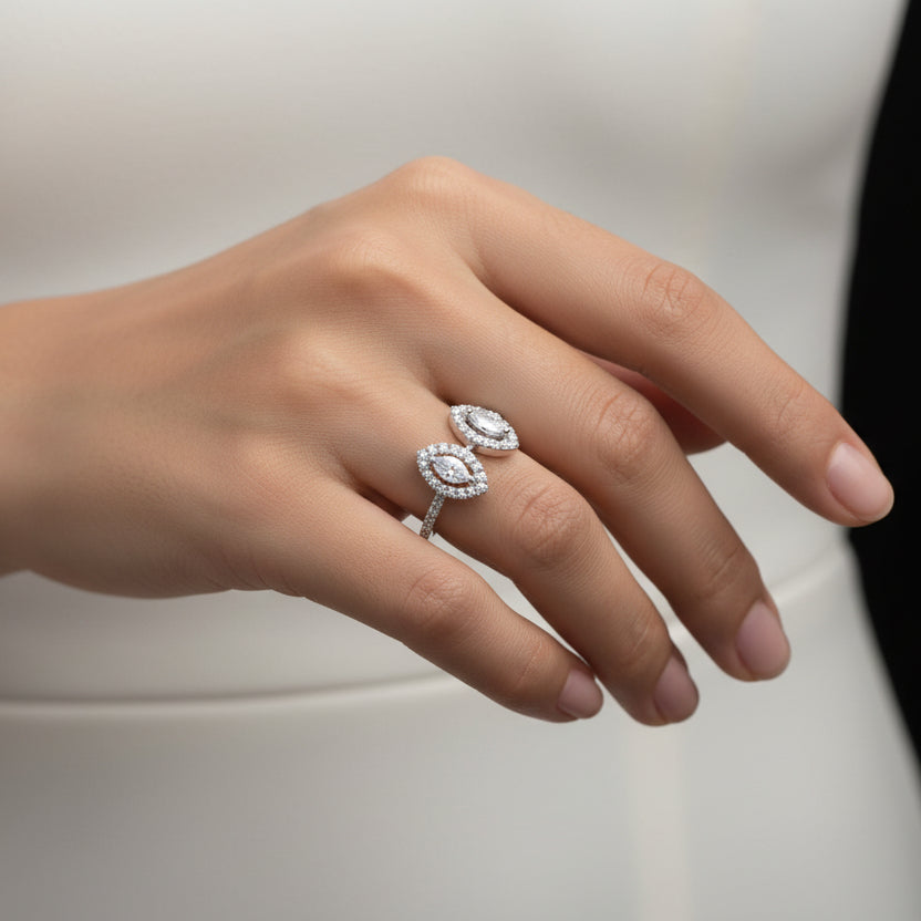 Silver earrings with gemstones on a dark background, featuring the brand 'Saheli'.