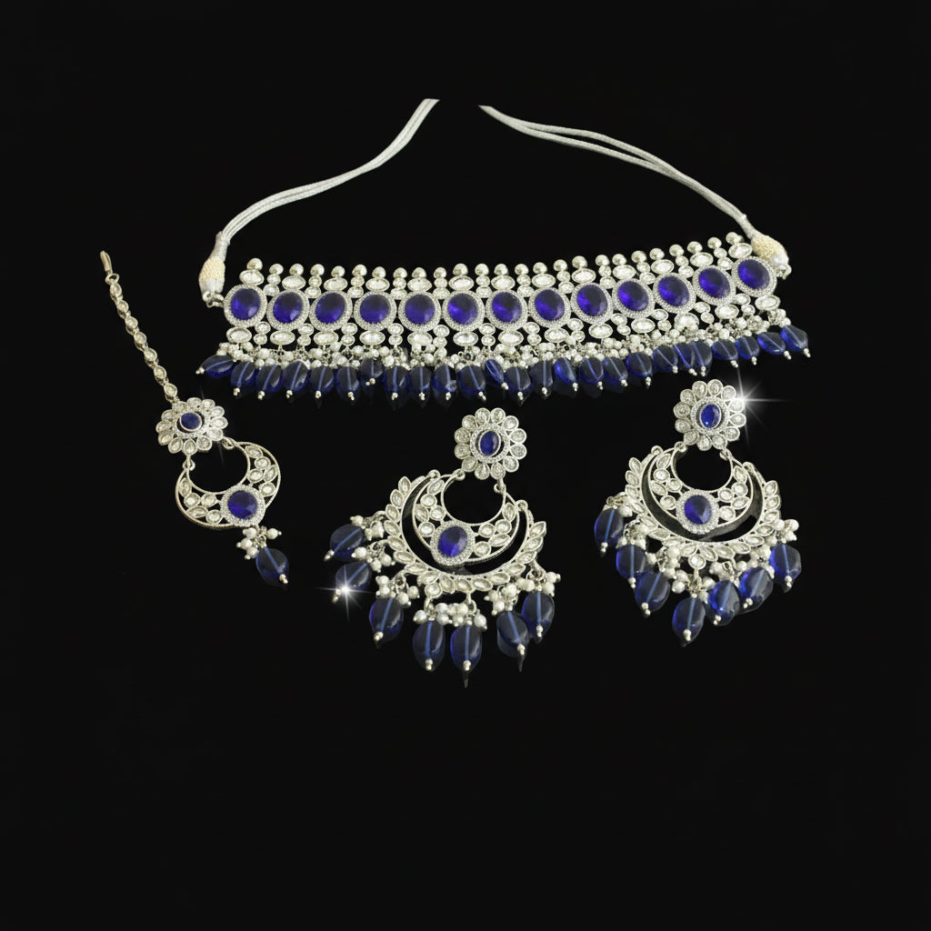 Silver and blue jewelry set on a dark background