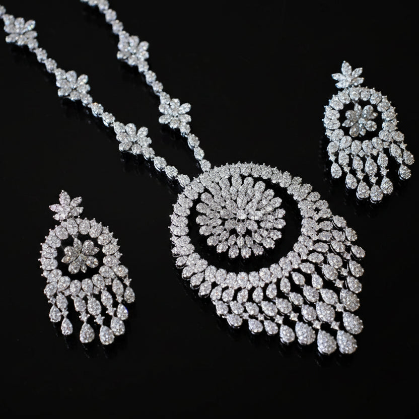 Diamond necklace and earrings set on a black background