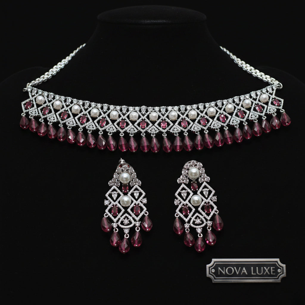 Jewelry set with necklace and earrings featuring red and silver design on a dark background, brand 'Saheli' visible.