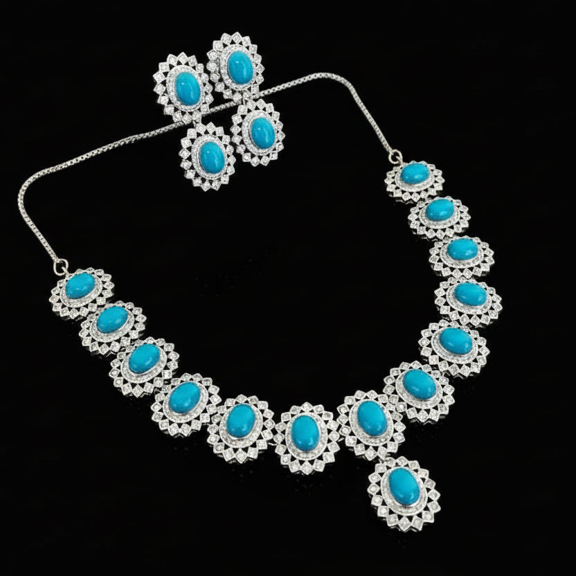 Jewelry set with necklace and earrings featuring blue stones on a dark background, branded 'SAHELI'.