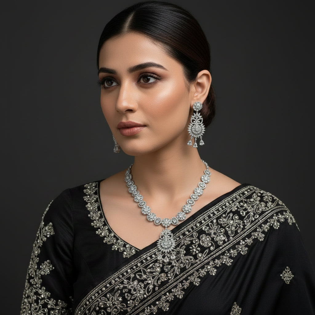Silver jewelry set with necklace and earrings on a dark background