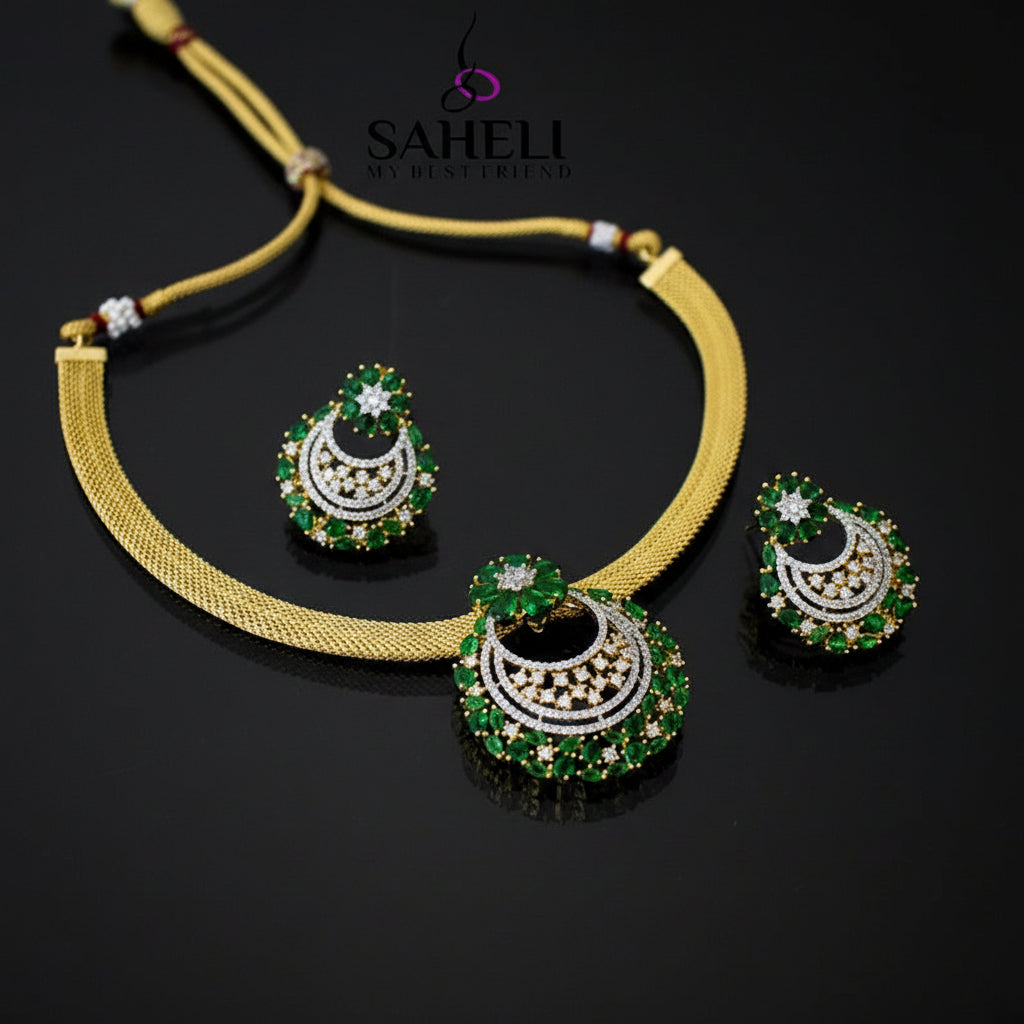 Gold necklace with green and white gemstone earrings on a dark background, featuring the brand 'Saheli'.