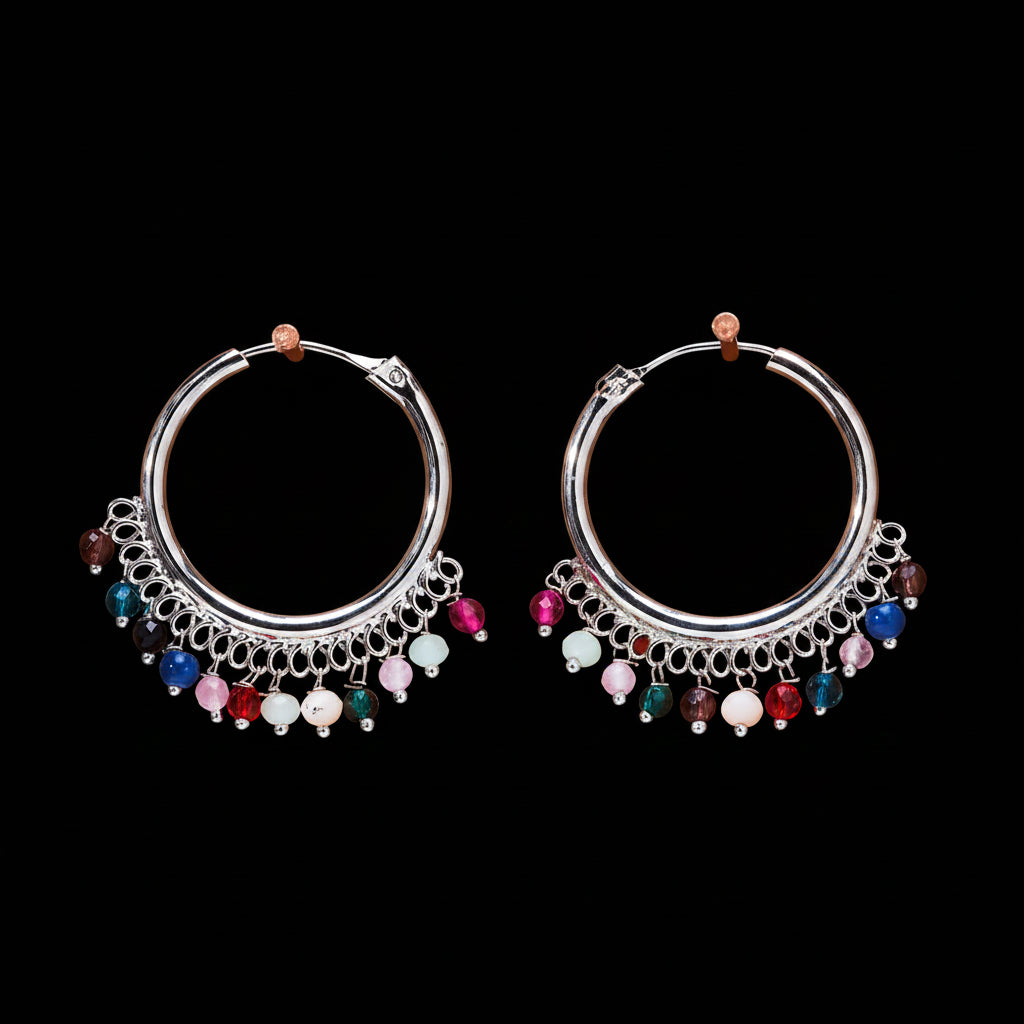 Pair of silver hoop earrings with colorful beads on a brown background