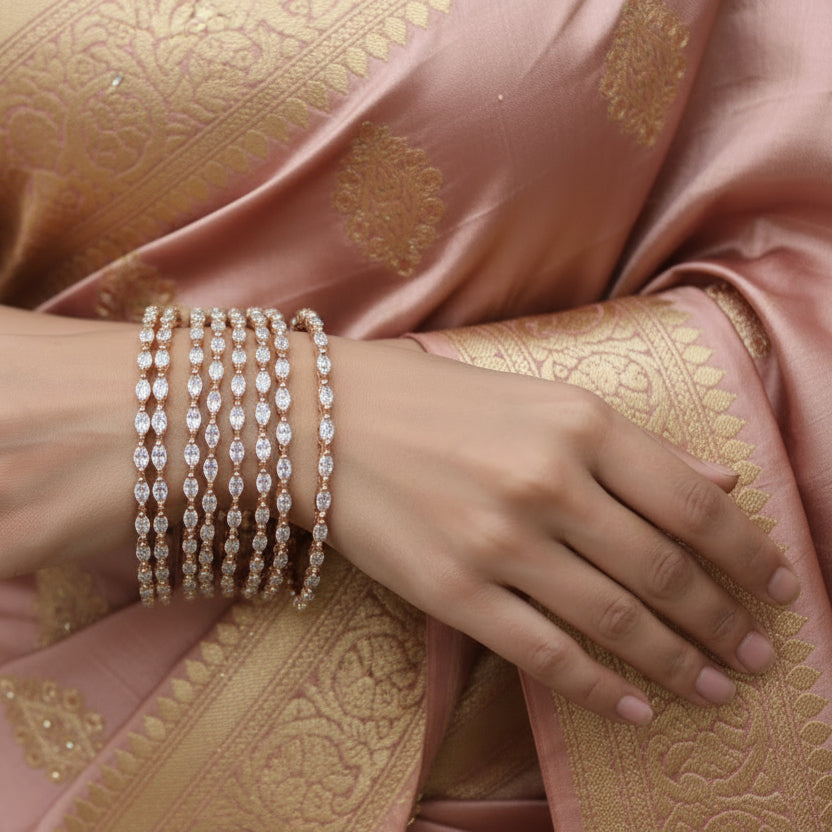 Set of diamond-studded bangles on a black stand with 'Saheli' branding.