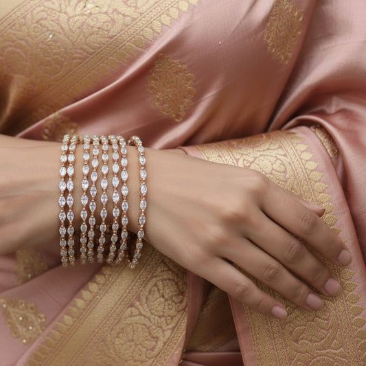 Set of diamond-studded bangles on a black stand with 'Saheli' branding.