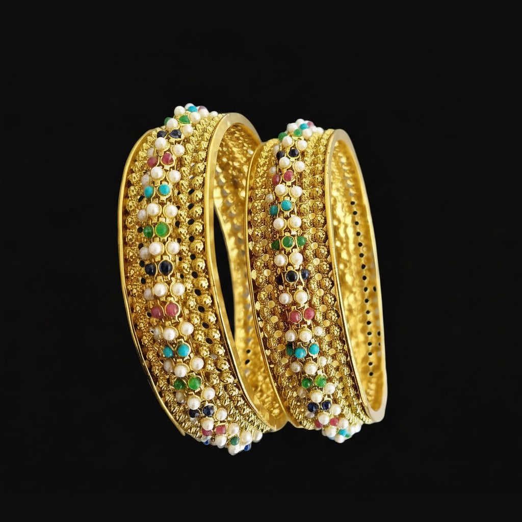Gold bangles with colorful stones on a gray background, featuring the brand 'Saheli'.