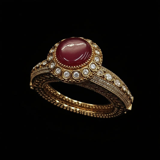 Gold ring with a red gemstone on a dark background
