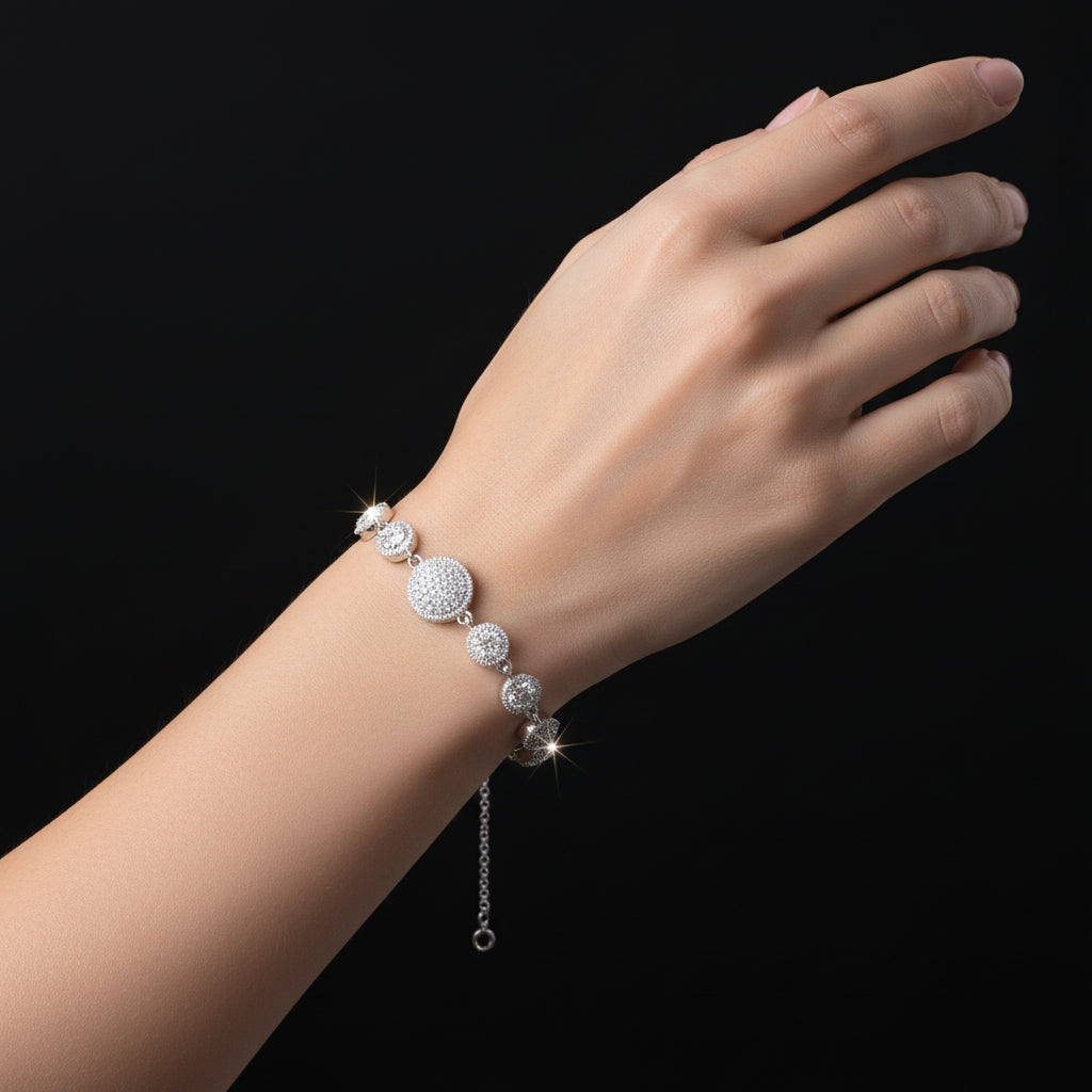 Silver bracelet with circular beads on a black background, featuring the brand 'Saheli'.