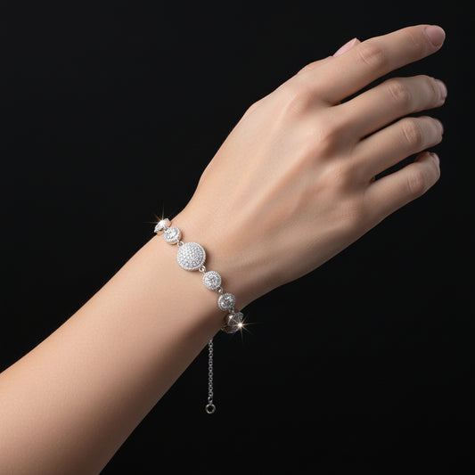 Silver bracelet with circular beads on a black background, featuring the brand 'Saheli'.