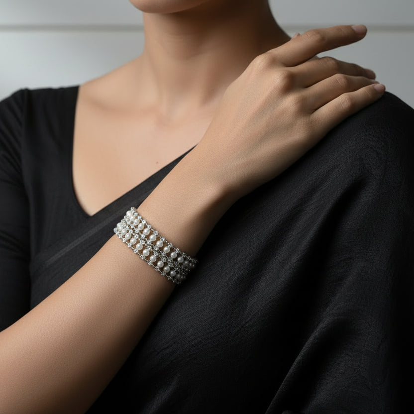 Pearl bracelet on a dark background with 'SAHELI' branding.