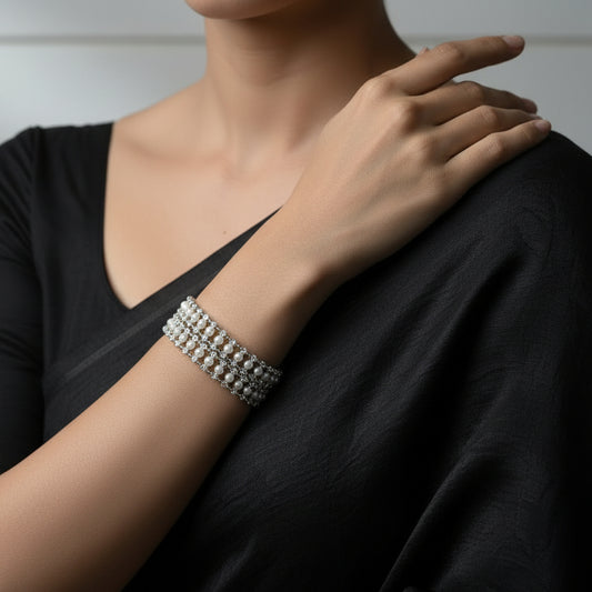 Pearl bracelet on a dark background with 'SAHELI' branding.