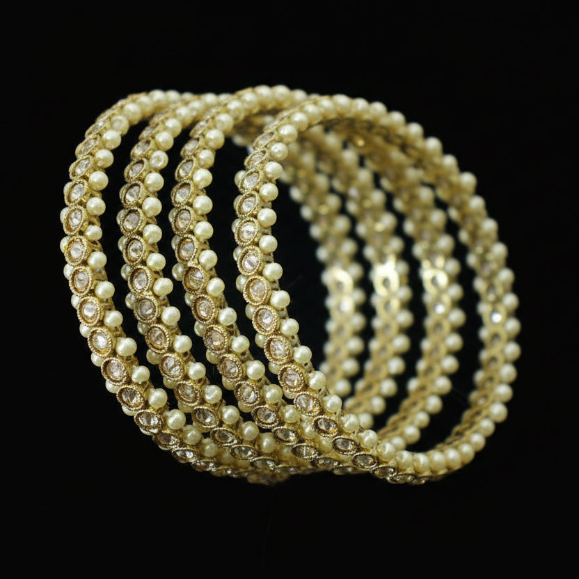 Set of pearl bangles on a dark gray stand with 'SAHELI' branding.