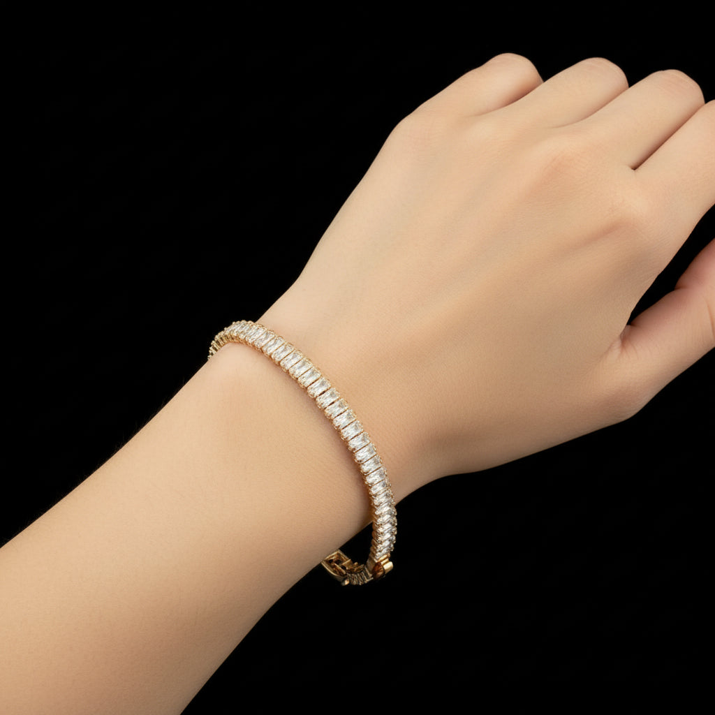 Gold bracelet with diamond-like stones on a dark background