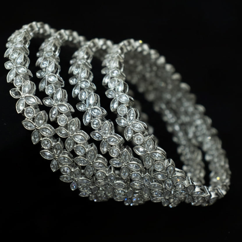 Silver beaded necklace on a dark background