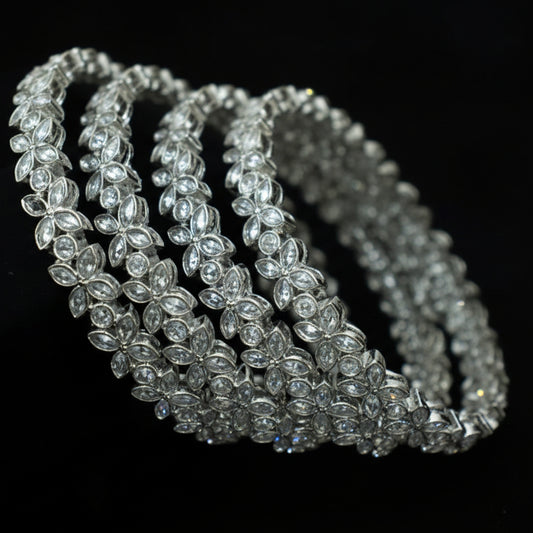 Silver beaded necklace on a dark background