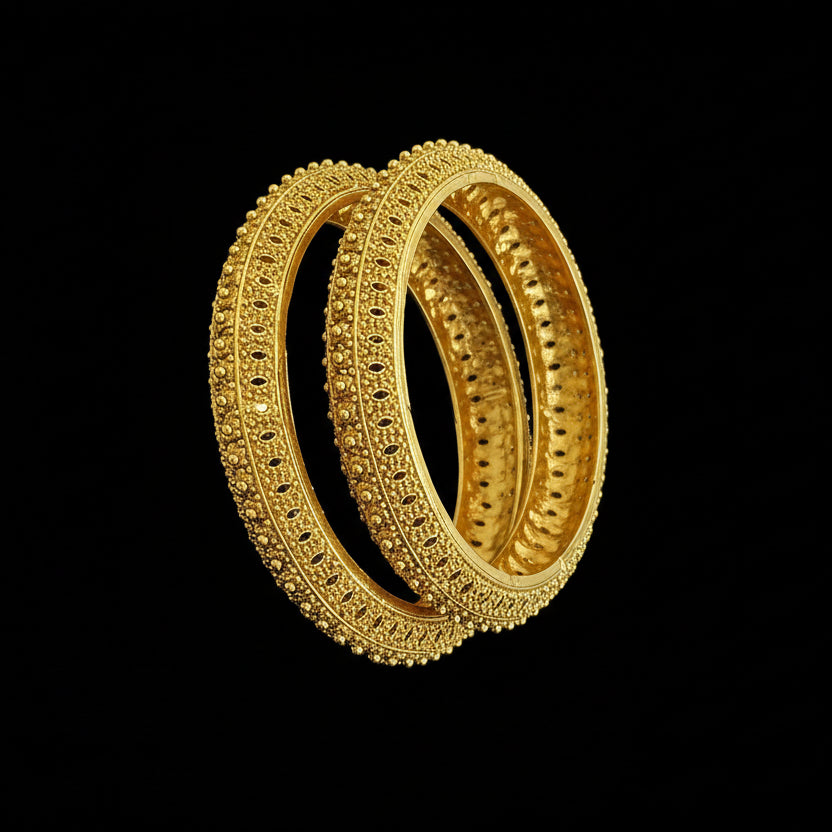 Pair of gold hoop earrings on a black stand against a gray background