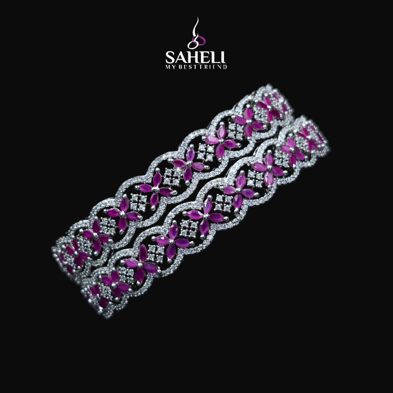 Decorative headband with pink and silver design on a black background, featuring the brand 'SAHELI'.