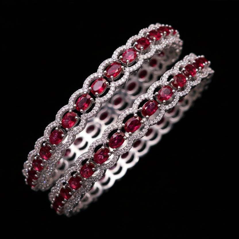 Two red gemstone bracelets on a dark background with 'SAHELI' branding.
