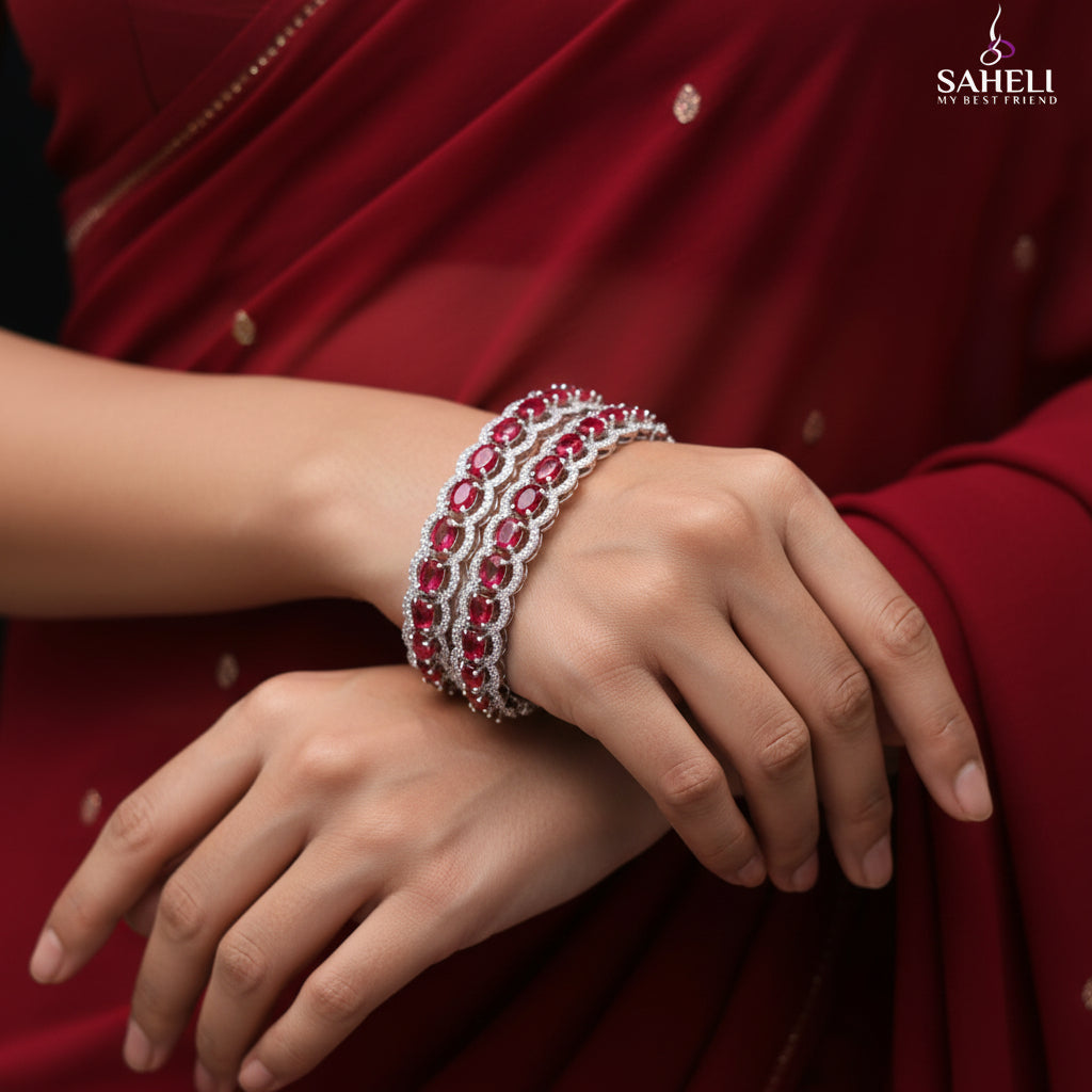 Two red gemstone bracelets on a dark background with 'SAHELI' branding.
